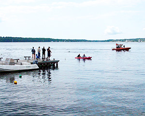 lifeguards, kayakers and a police boat protecting swimmers
